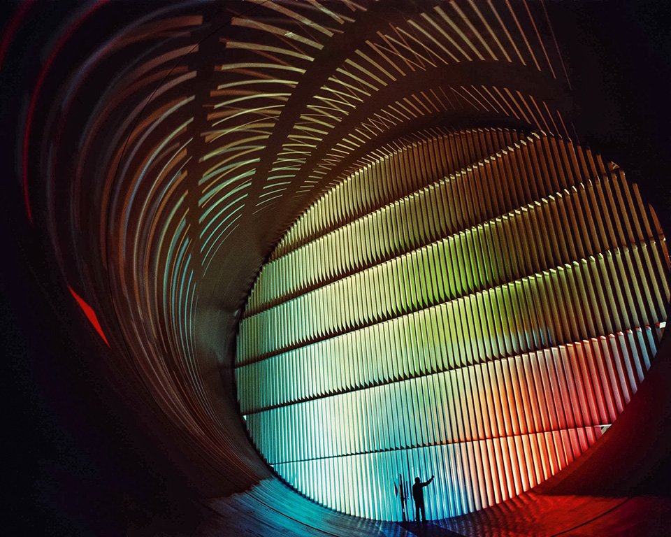 A technician prepares to unlatch a small door built into the guide vanes of the Transonic Wind Tunnel at Langley Research Center in 2010. The vanes prevent turbulent eddies from interfering with the tests. Copyright: Courtesy of NASA